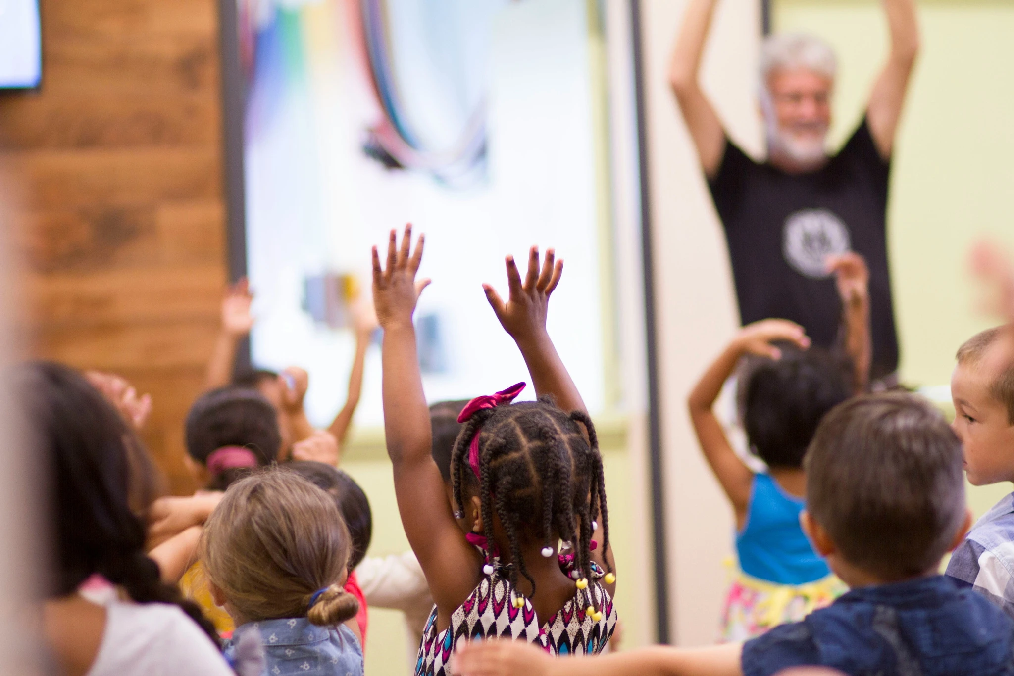 Students raising their hands in a classroom
